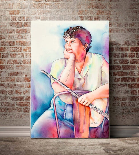 A framed watercolor painting of a woman sitting and holding a flute, displayed on a brick wall.