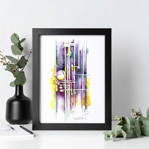 Framed abstract art piece with black frame on a white surface, surrounded by greenery.