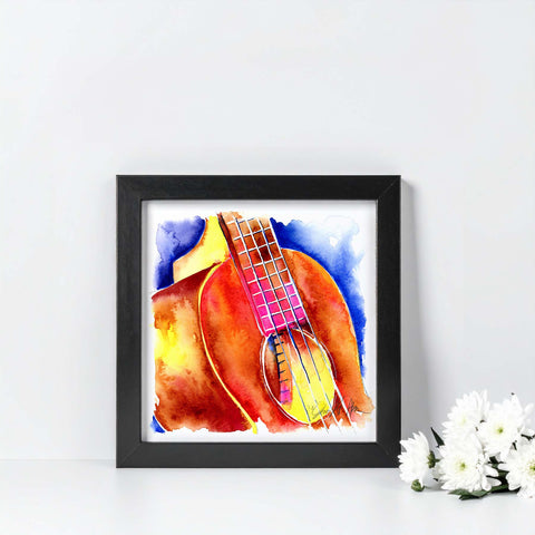 Framed artwork of a colorful guitar on a white wall with flowers in the corner.