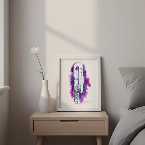 Framed artwork on a nightstand next to a white vase with a flower, against a neutral wall.