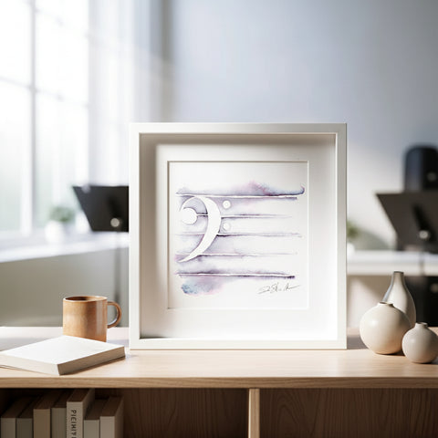 Framed artwork on a desk with books and vases in the background