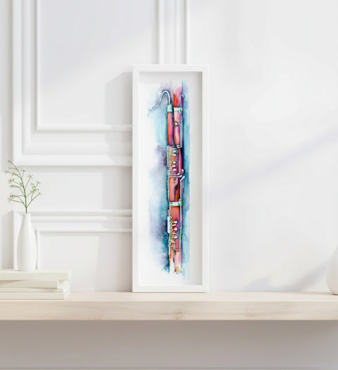 Framed artwork of a colorful abstract design on a white wall.