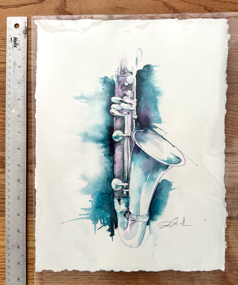 Watercolor painting of an alto clarinet on a white background with a ruler for scale.