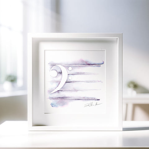 A framed painting of a bass clef symbol in shades of purple and white, with a signature at the bottom right corner, placed on a white surface in a well-lit room.