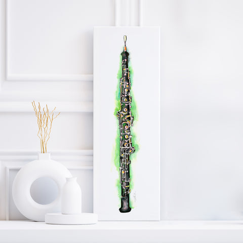 A canvas print of a black and green oboe watercolor painting, displayed on a white wall, with decorative objects to the side.