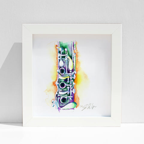 A framed art print featuring a colorful abstract representation of a clarinet on a white background.