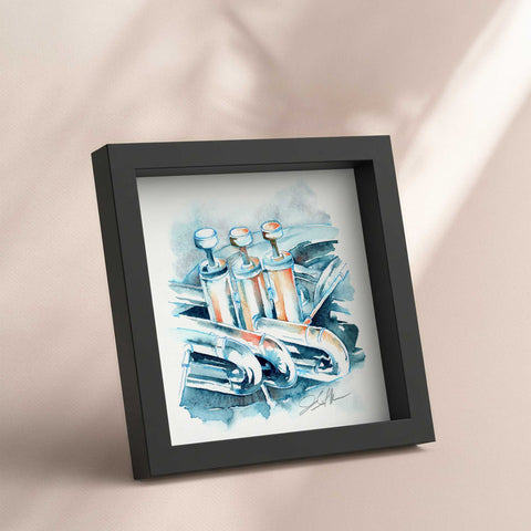 Framed artwork of a brass instrument on a beige background