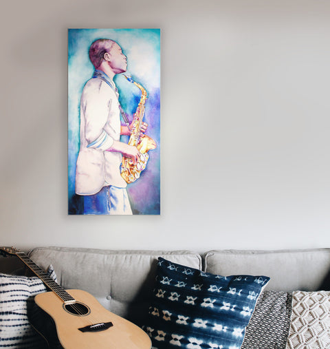 A watercolor and ink painting of a person playing a saxophone, displayed on a wall above a couch with guitar and decorative pillows.
