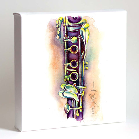 A framed watercolor print of a clarinet with deep purple and vibrant color accents displayed on white background.