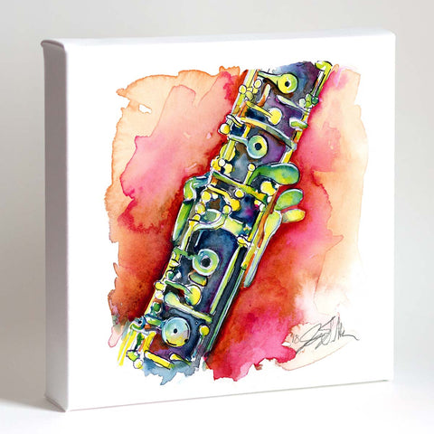 A framed print of a watercolor painting depicting a colorful oboe with a watermelon-like pattern on a red background