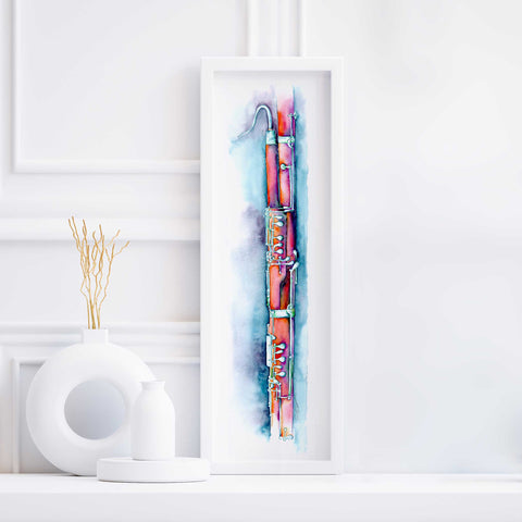 A framed watercolor and ink bassoon artwork displayed on a white wall, with a decorative object to the left.