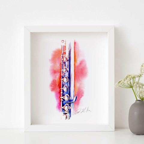 A framed watercolor painting of a flute with coral and blue colors on a white background, signed by the artist.