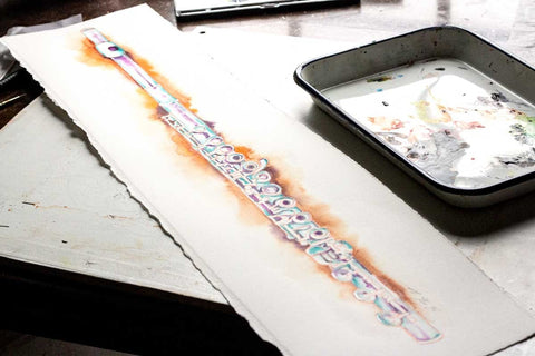 a watercolor of a flute sitting next to a messy pallette