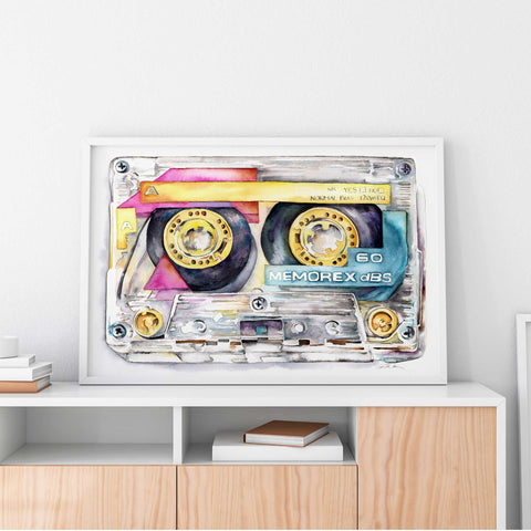 A large-scale watercolor painting of a Memorex cassette tape displayed on a white wall above a wooden shelf with books.
