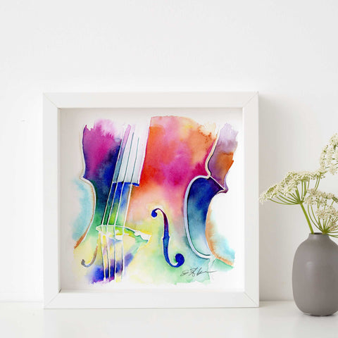 A colorful watercolor print of a cello on white paper, with vibrant streaks of blue, pink, yellow, and purple.