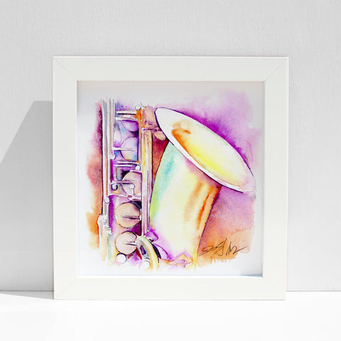 A framed watercolor painting of an iridescent tenor saxophone with a colorful background, displayed against a white background.