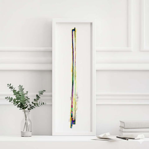 Framed abstract artwork with a vertical violin bow on a white wall.