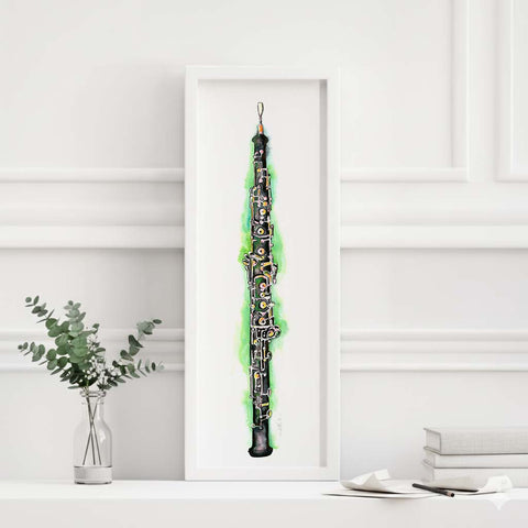 Framed artwork of a green and black abstract oboe design on a white wall.
