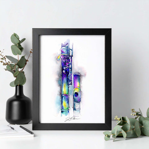 Framed artwork of a colorful flute on a white surface with greenery.
