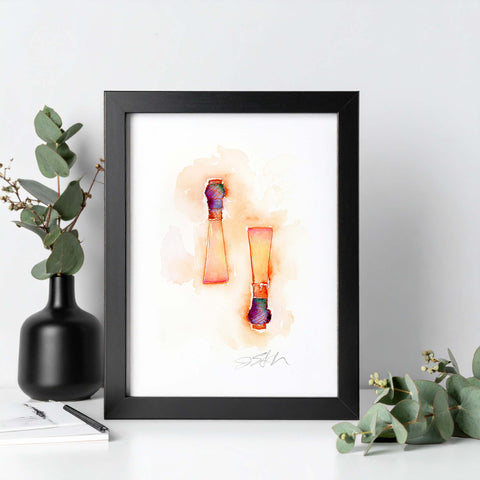 Framed artwork of colorful abstract reed design on a white wall with decorative elements.