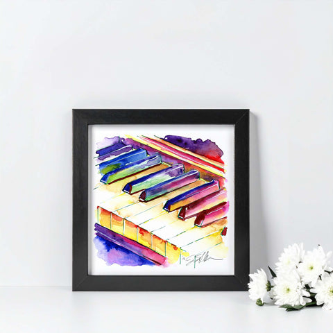 Framed colorful painting of piano keys on a white wall with flowers.