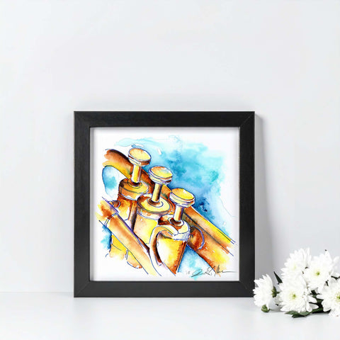 Framed artwork of a watercolor painting of brass instruments on a white wall with flowers.