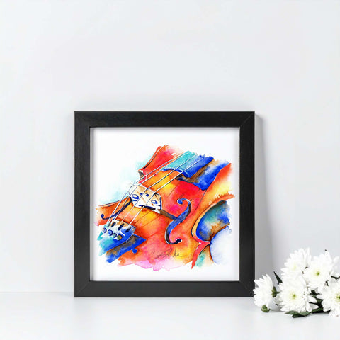 Framed colorful abstract painting of a violin on a white wall with flowers.