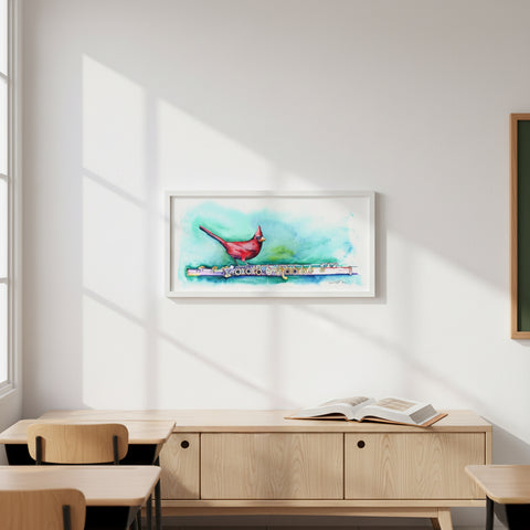 Framed artwork of a colorful painting on a wall in a room with wooden furniture.