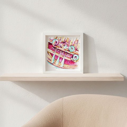 Framed artwork of a colorful horn design on a white wall.