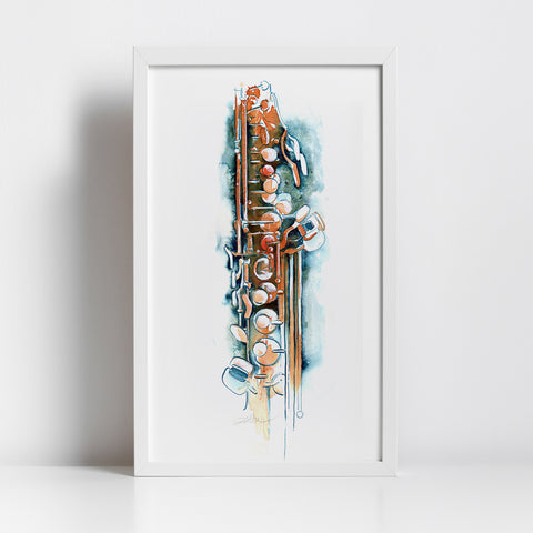 A framed watercolor art print of a saxophone, featuring expressive blue, brown, and gold brushstrokes on a white background, housed in a clean white frame and leaning against a white wall.