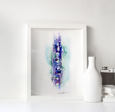 Framed artwork of a blue and purple abstract clarinet design on a white surface with a white vase and camera.