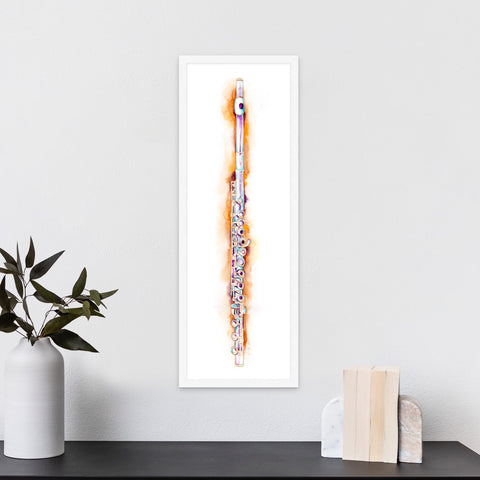 Framed abstract artwork on a white wall with a plant and books below.