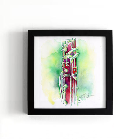Framed artwork of a red and green musical instrument on a white background