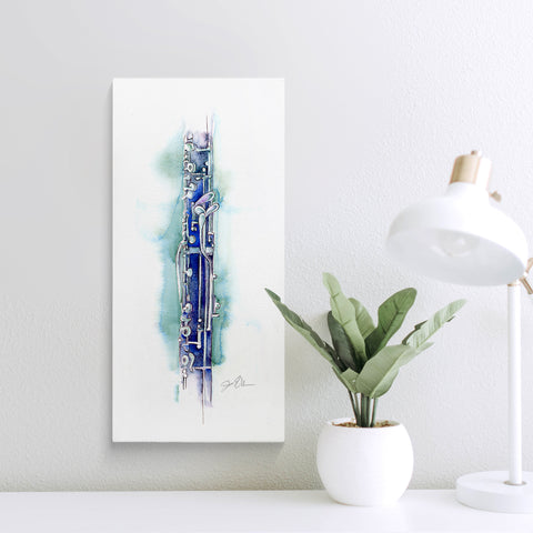 Framed artwork of a english horn on a wall next to a plant and lamp.