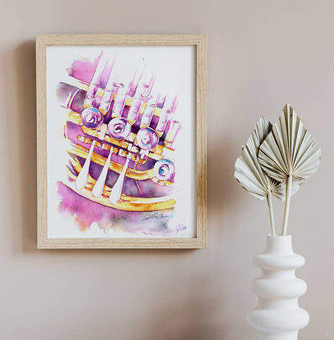 Framed watercolor painting of a colorful french horn on a wall next to a white vase with dried leaves.