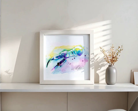 Framed colorful painting on a white shelf with a vase and books in a minimalistic room.