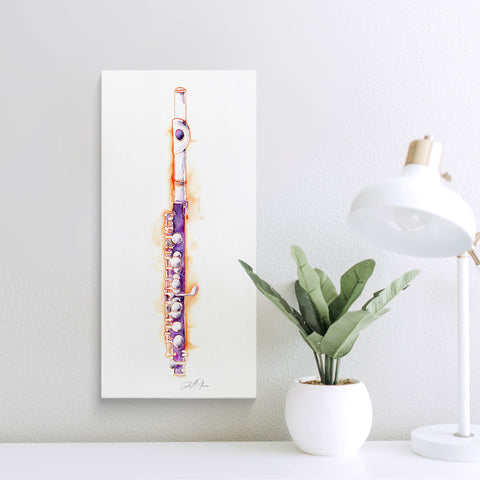 Framed artwork of a piccolo on a white wall with a plant and lamp in the foreground.