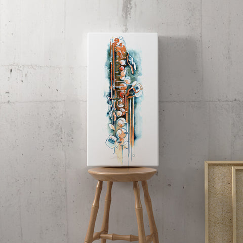 A tall rectangular white wall art print featuring an abstract saxophone illustration in orange, teal, and cream tones, displayed upright on a wooden stool against a textured concrete wall.